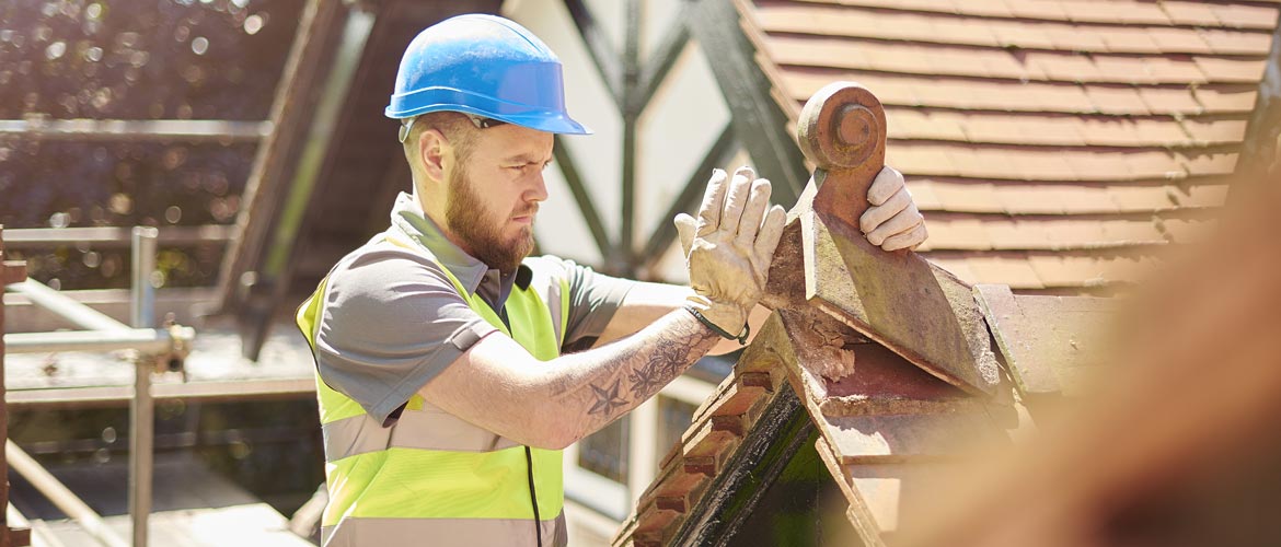 Man working outside fixing a roof