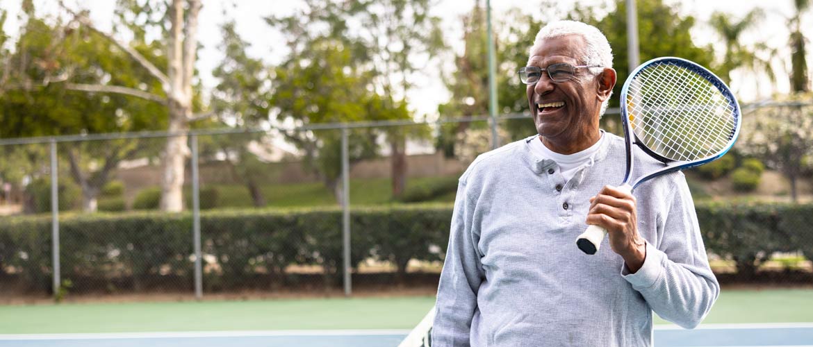 man with tennis racket over shoulder