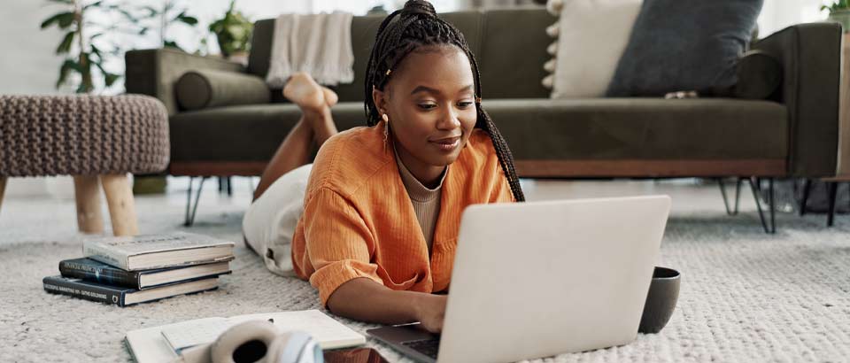 girl laying on floor with laptop in front of her