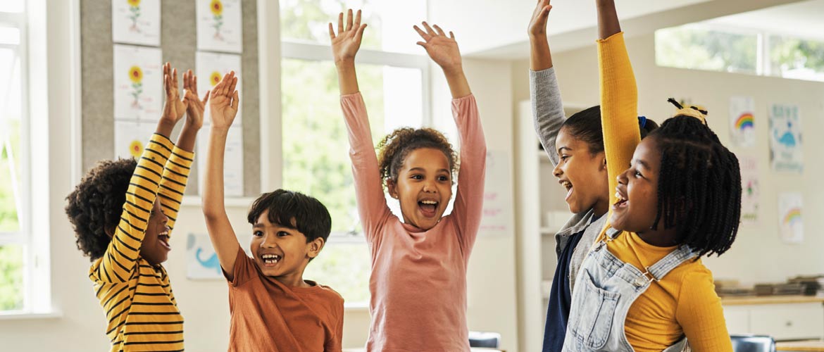 kids raising hands smiling