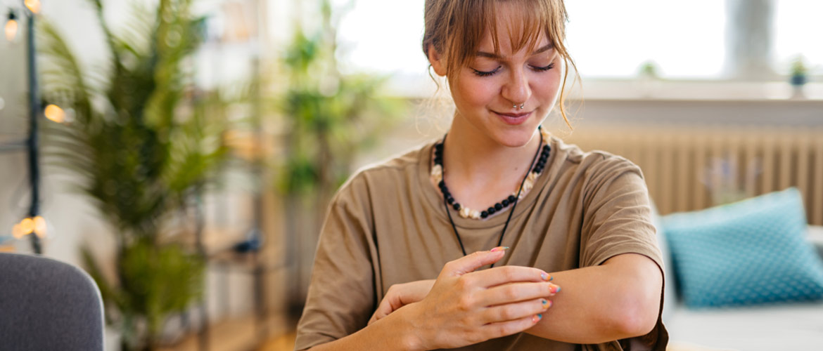 young woman touches her arm as if to check healing progress of ringworm