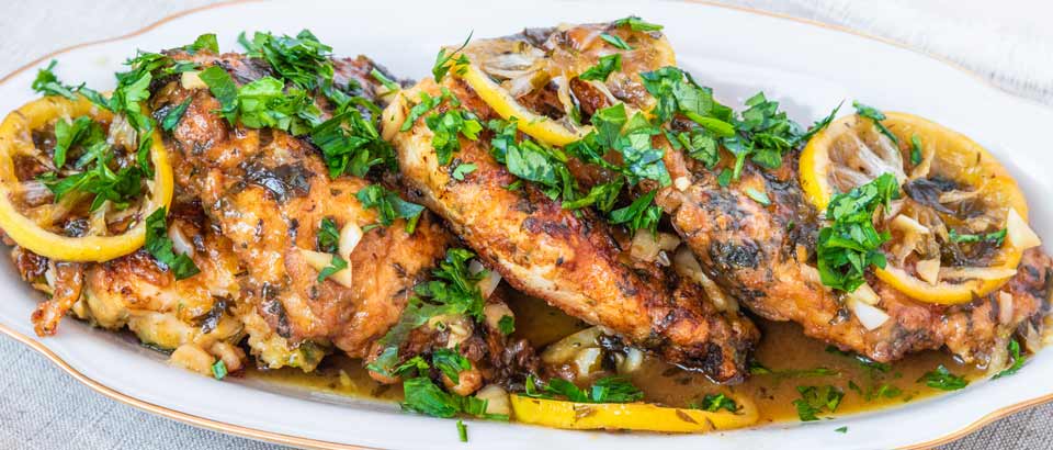 platter with grilled chicken, lemon, garlic and herbs