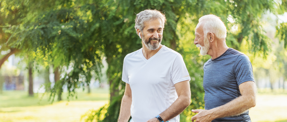 two older men walking outside