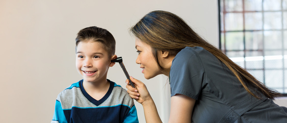 nurse checking a boys ear