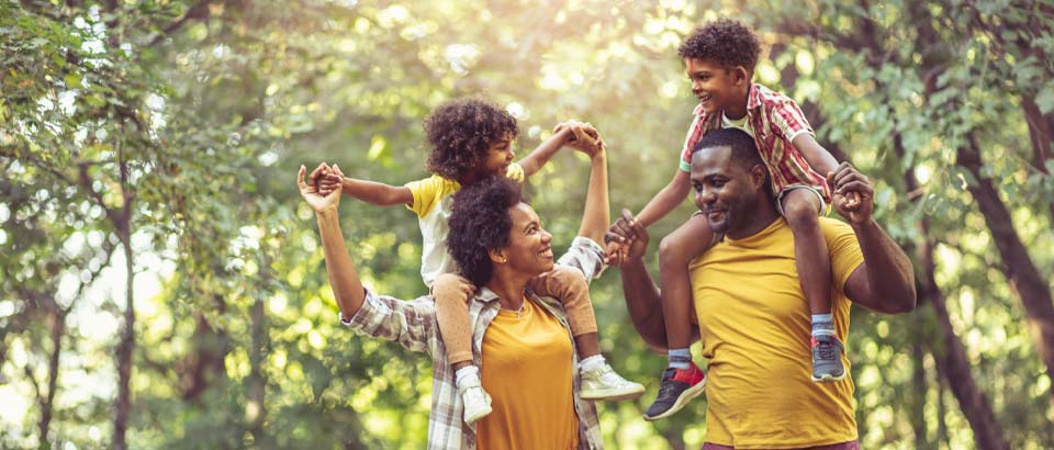 a family of four walking together outside