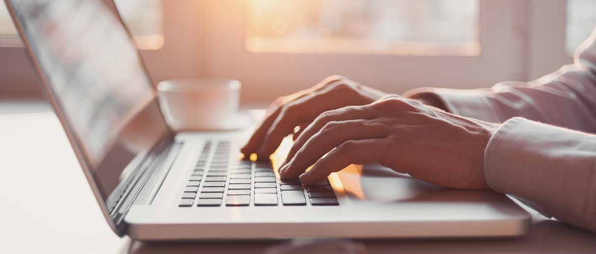 Hands on a laptop keyboard