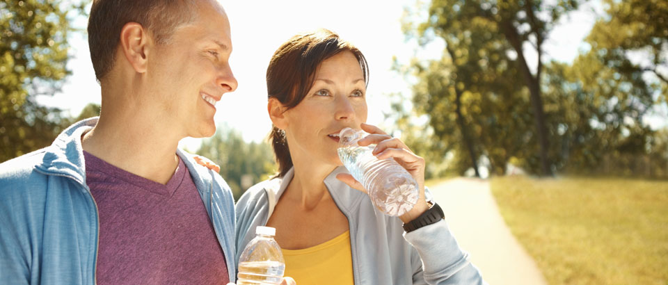 man and woman drinking water