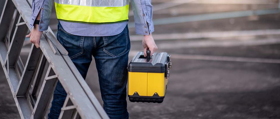 person holding toolbox and ladder