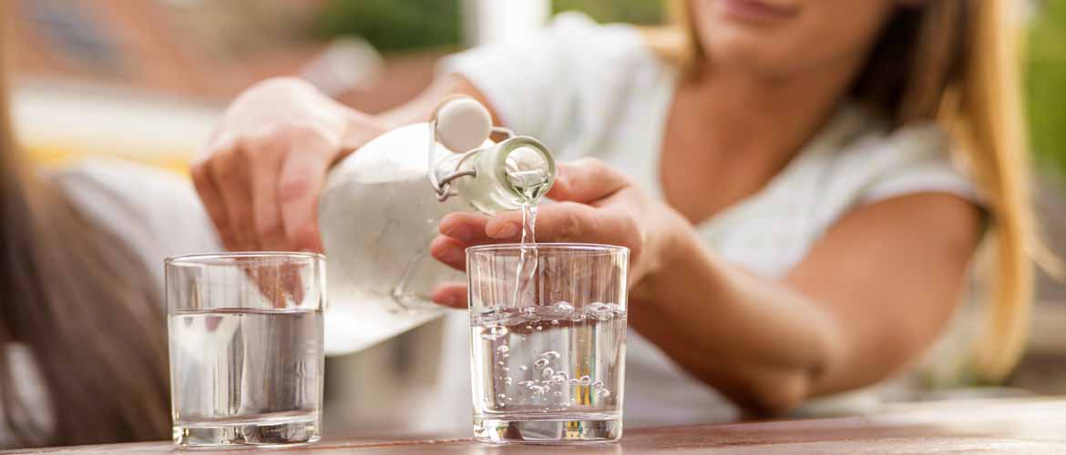 a woman pouring a glass of water