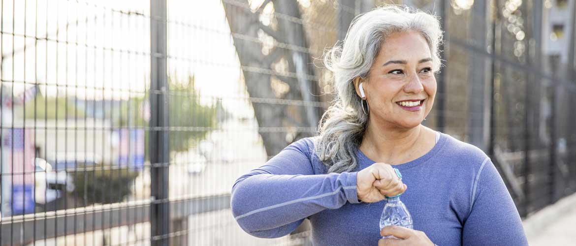 woman opening a water bottle after jogging