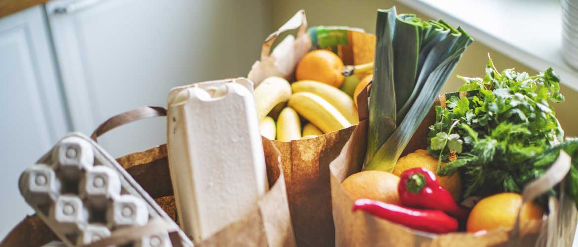 bags of groceries sitting on a kitchen table