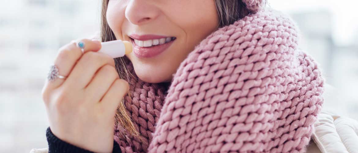 woman applying lip balm