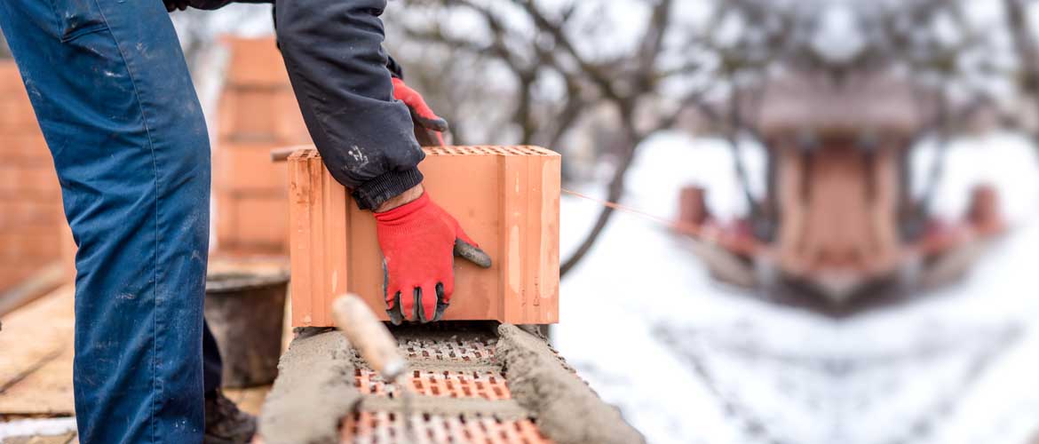 worker laying bricks