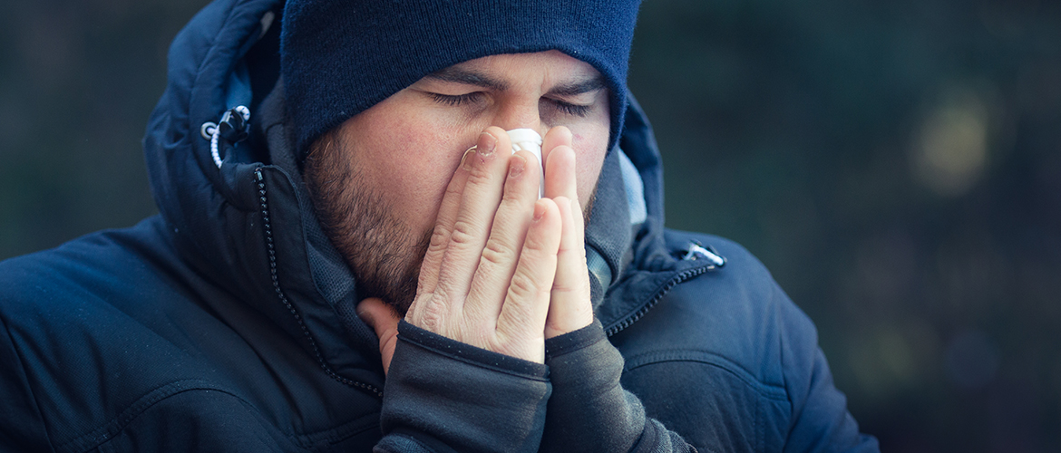 man blowing nose