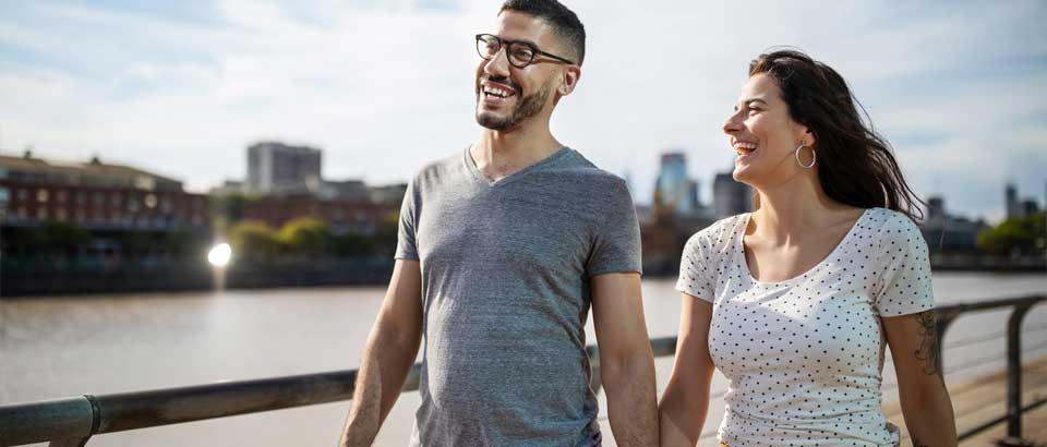 man and woman walking smiling