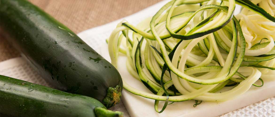 zucchini on cutting board sliced into small strips