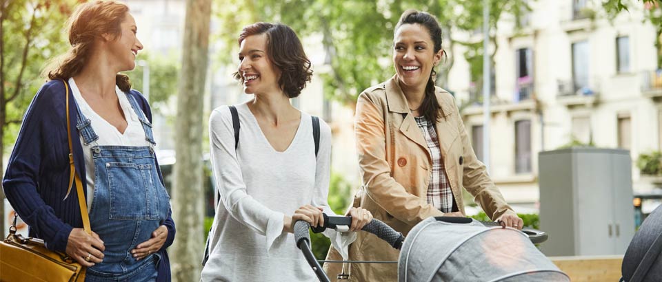 pregnant women walking with her friends in the park